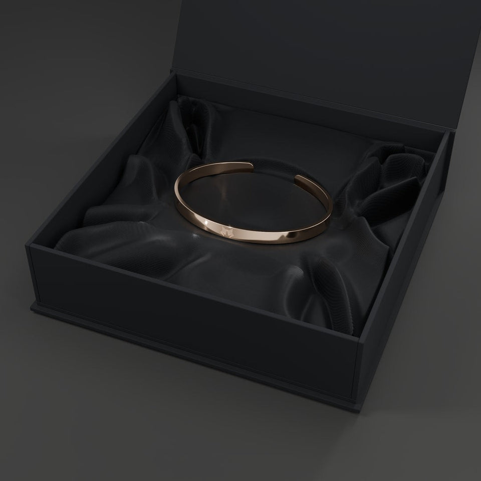 Close view of the Rose Gold HOWL bracelet held in place within the open box