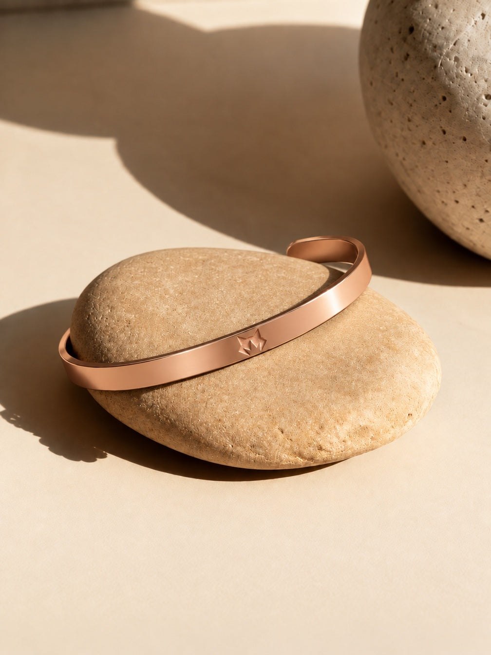 Rose Gold Signature Cuff on sunlit stone