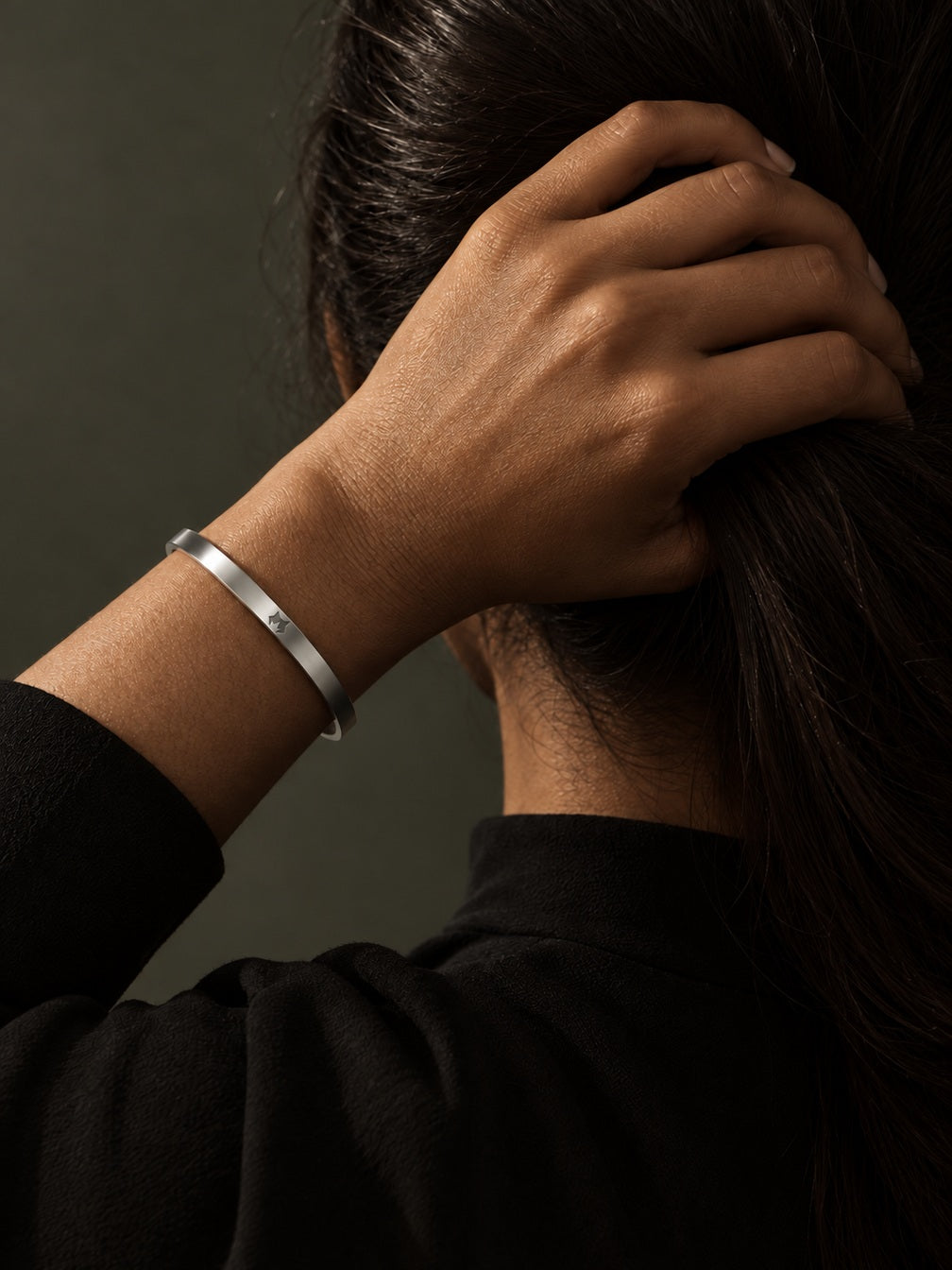 Silver Signature Cuff worn on the wrist